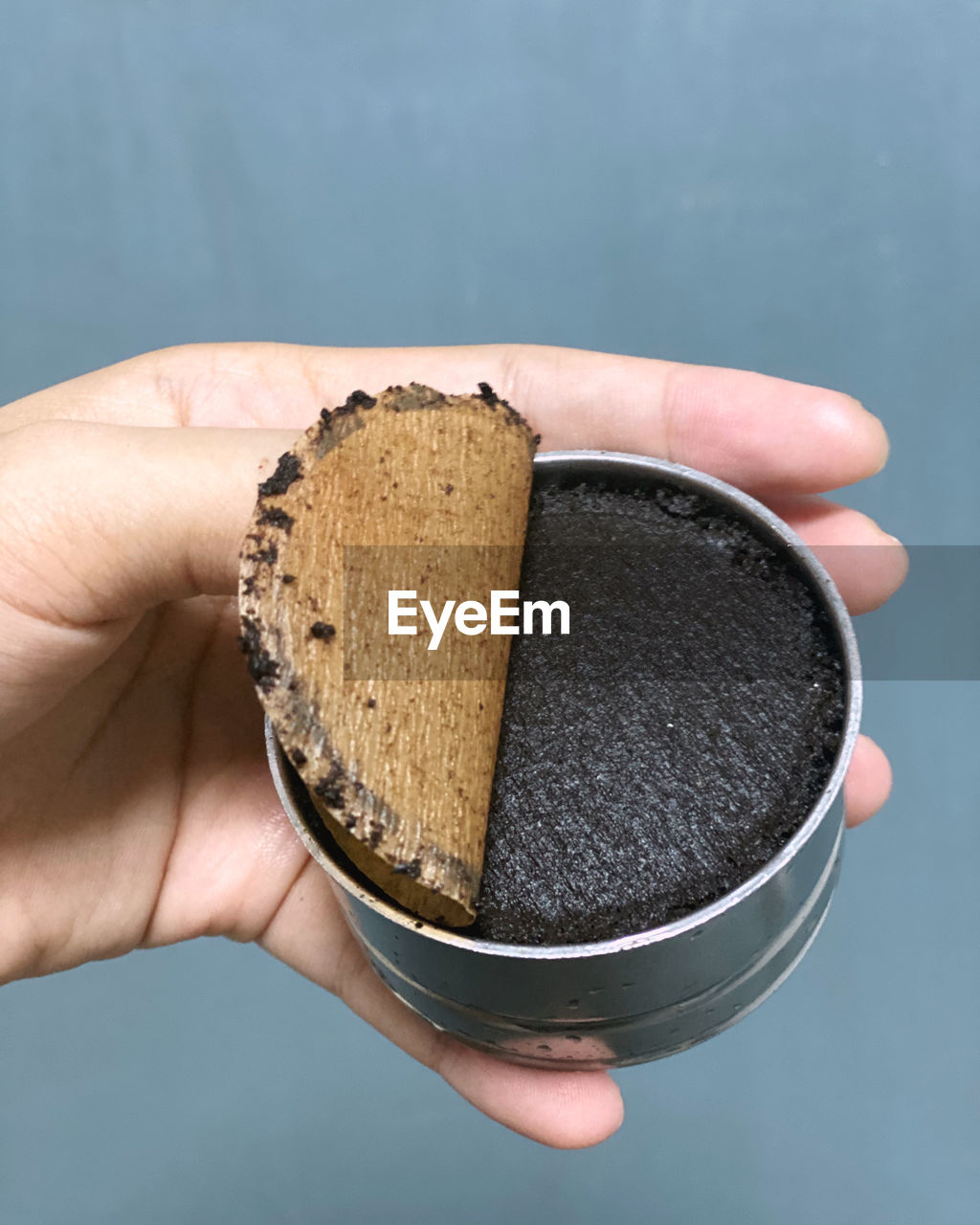 Close-up of hand holding coffee grounds