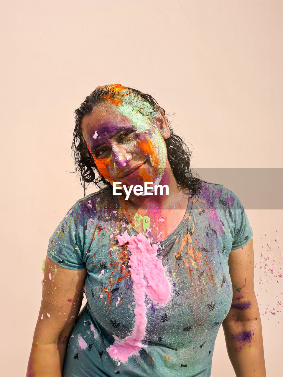 Portrait of happy indian woman celebrating holi with powder colours or gulal. indian festival holi.