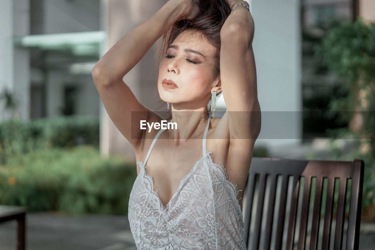 Portrait of young woman standing outdoors