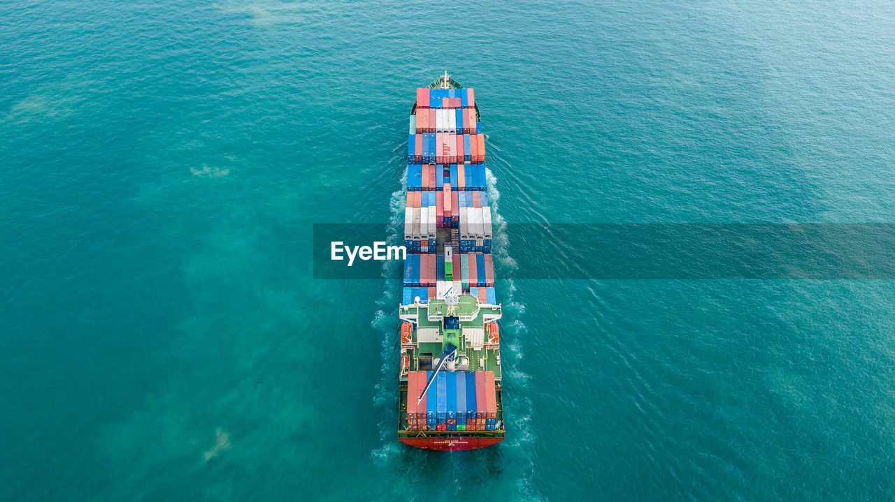 High angle view of cargo containers in ship sailing on sea