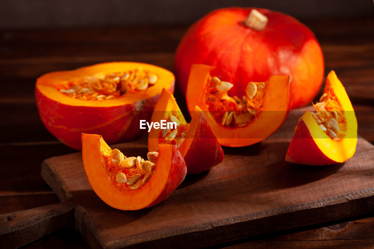 A sliced orange pumpkin on a dark background