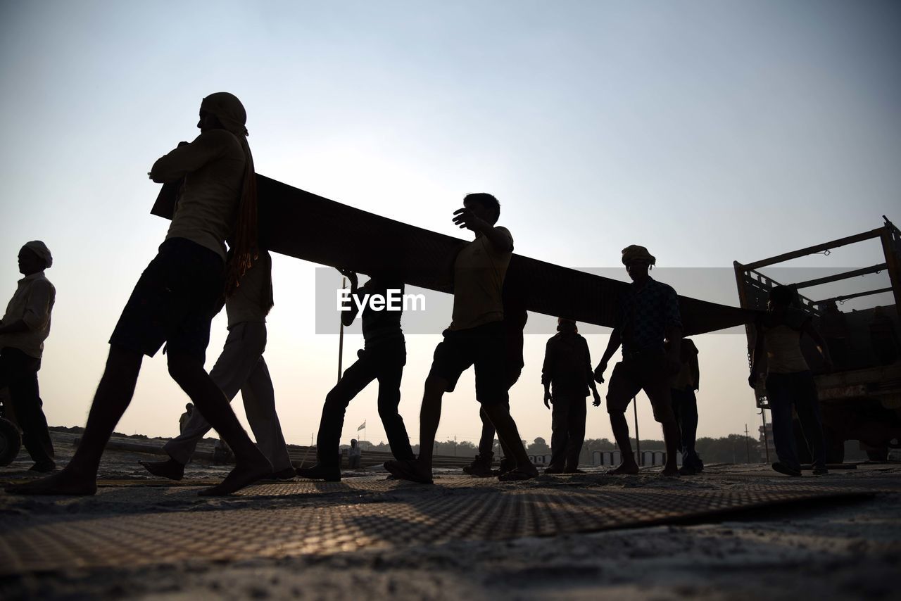 SILHOUETTE PEOPLE STANDING AGAINST SKY DURING SUNSET