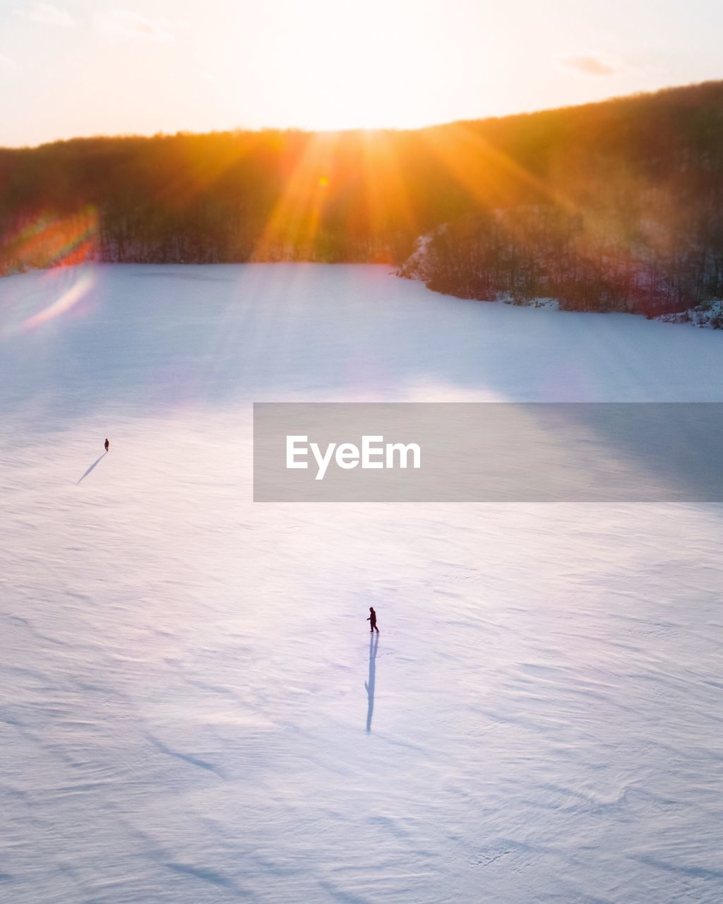 High angle view of snow covered field on sunny day