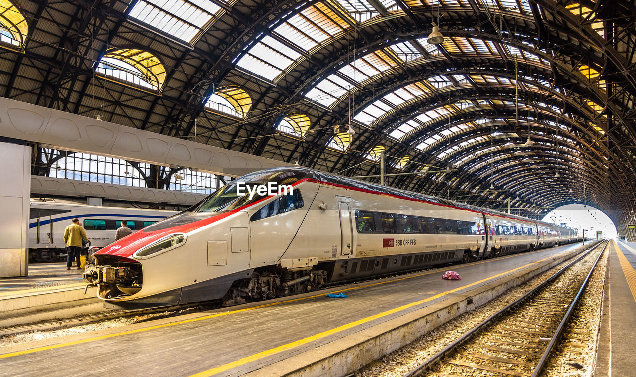 TRAIN ON RAILROAD STATION PLATFORM