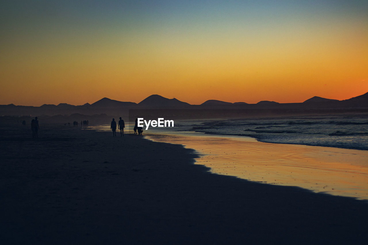 Scenic view of beach against sky during sunset