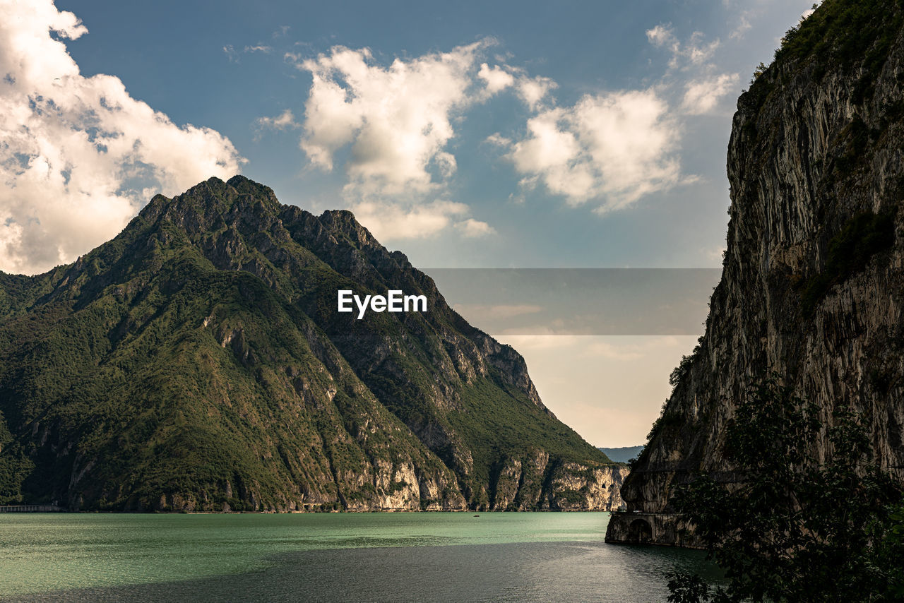 Scenic view of sea and mountains against sky