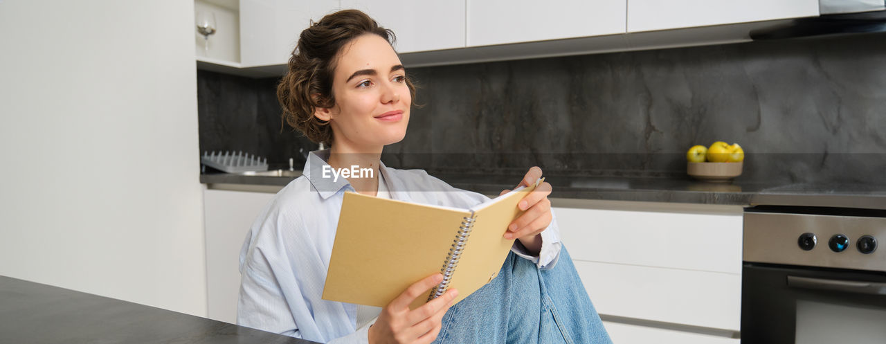 portrait of young woman using digital tablet at home