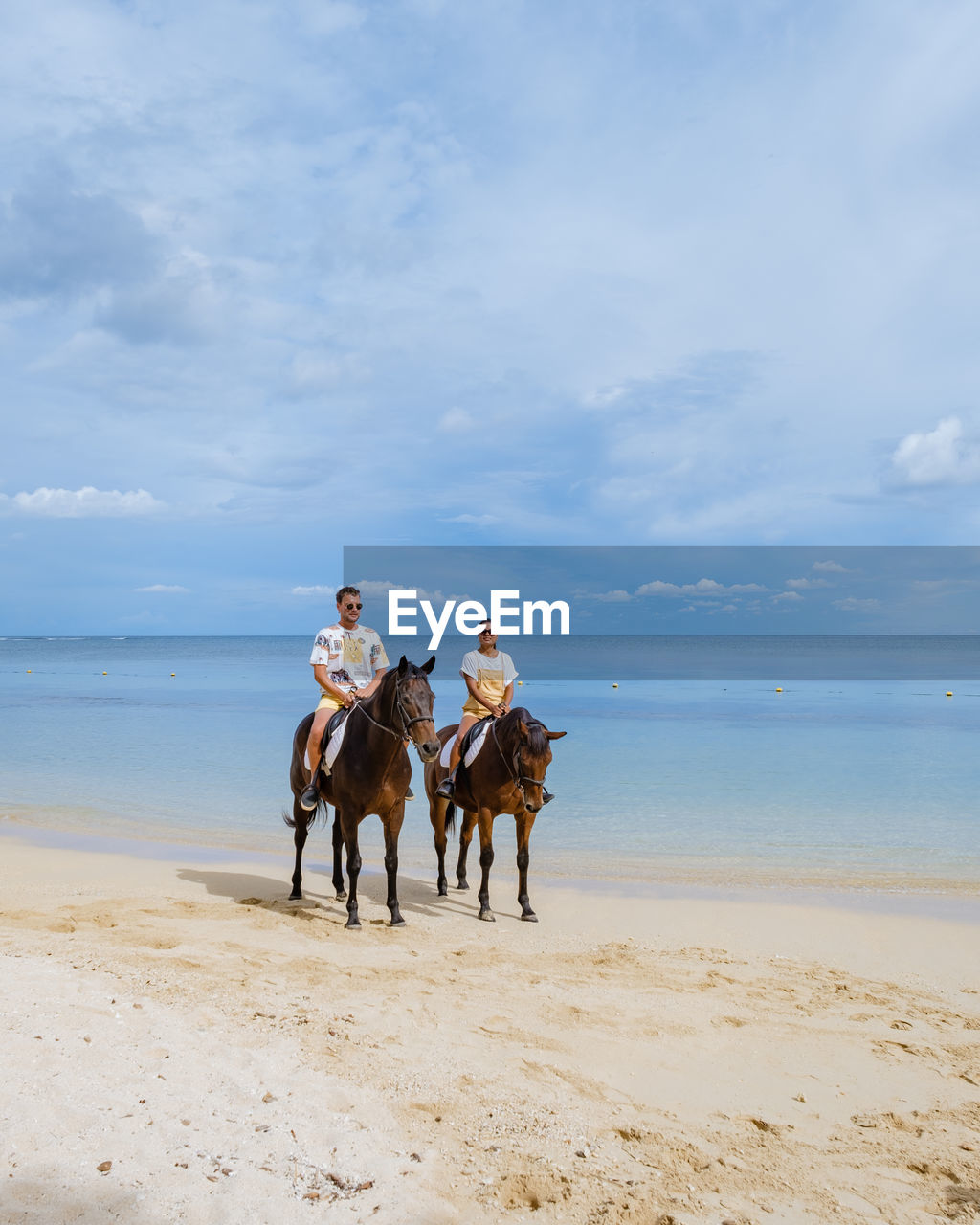 Man and woman sitting on horse