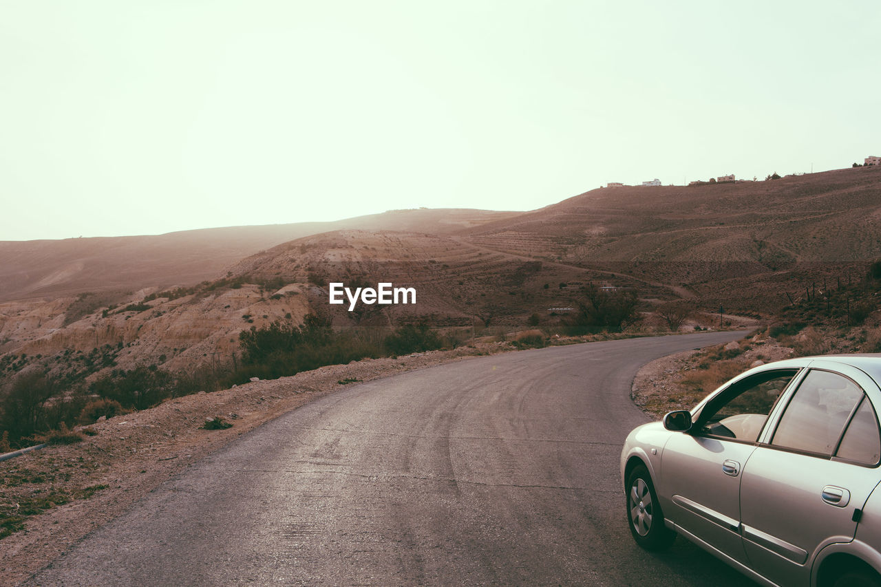 Car on road against clear sky