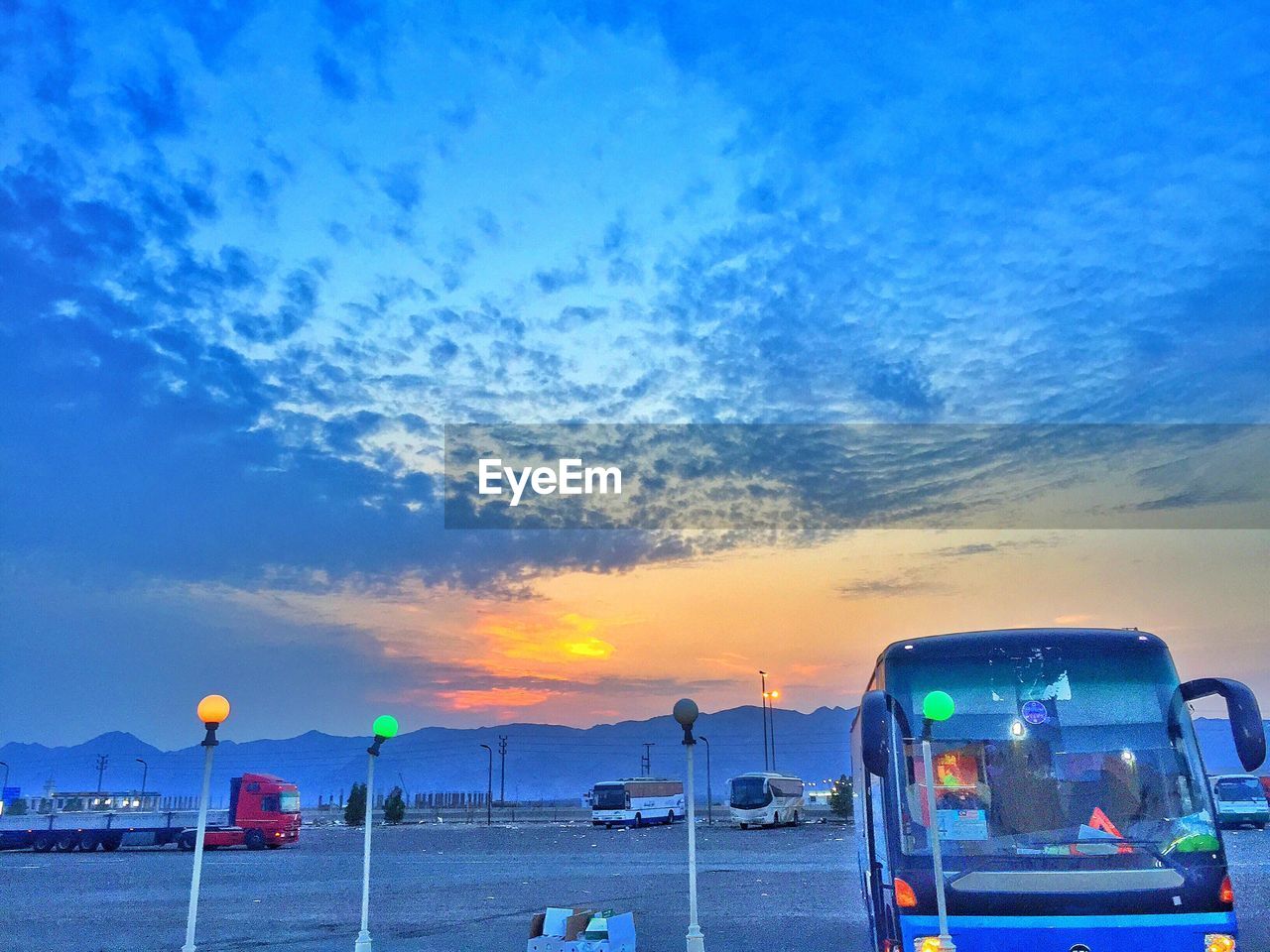 VIEW OF ROAD AGAINST CLOUDY SKY DURING SUNSET