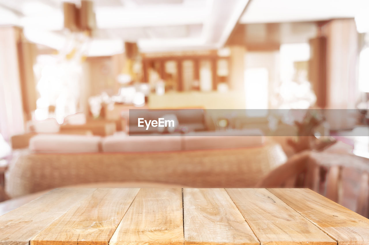 CLOSE-UP OF WOODEN TABLE AT HOME