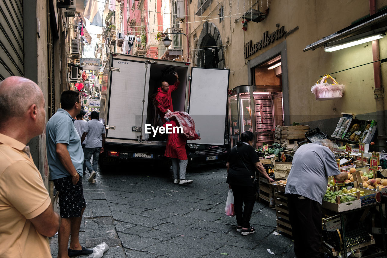 GROUP OF PEOPLE IN MARKET