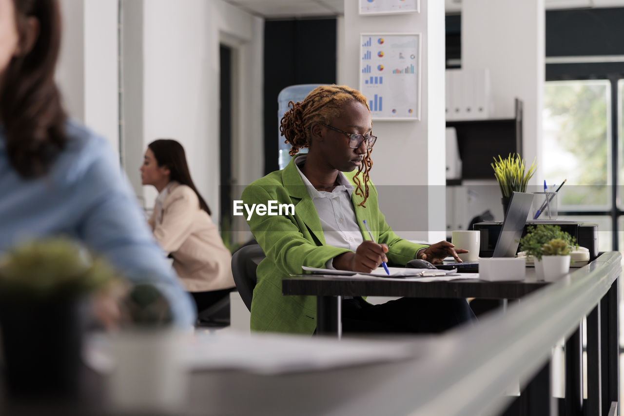 side view of business colleagues working on table