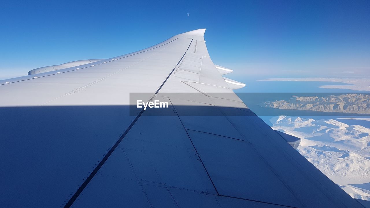 LOW ANGLE VIEW OF AIRCRAFT WING AGAINST SKY