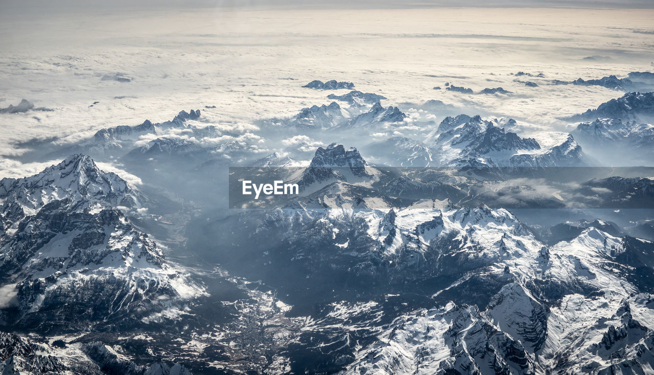 An aerial view of cortina d'ampezzo and the surrounding ridges in the dolomites alps while flying