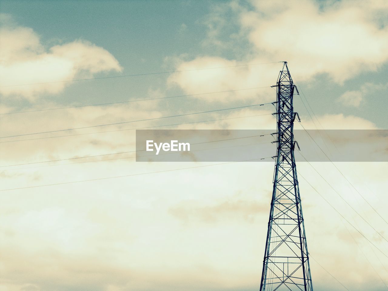 LOW ANGLE VIEW OF POWER LINES AGAINST CLOUDY SKY