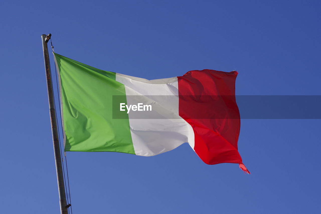 LOW ANGLE VIEW OF FLAG FLAGS AGAINST CLEAR BLUE SKY
