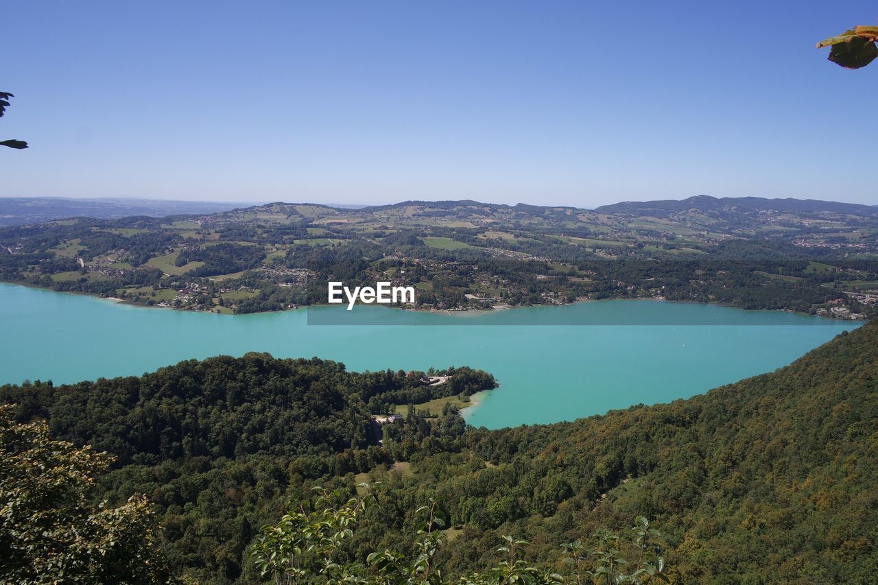 Scenic view of lake against clear blue sky