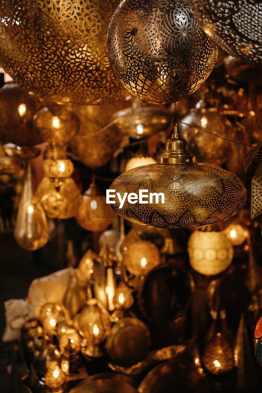 Closeup of various moroccan traditional antique lanterns and lamps hanging on local market in marrakesh city