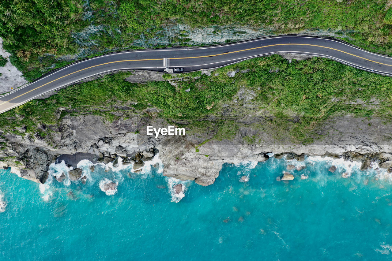 Aerial view of road on cliff by sea