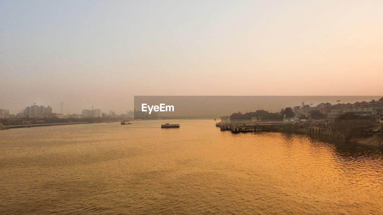 Scenic view of buildings against sky during sunset