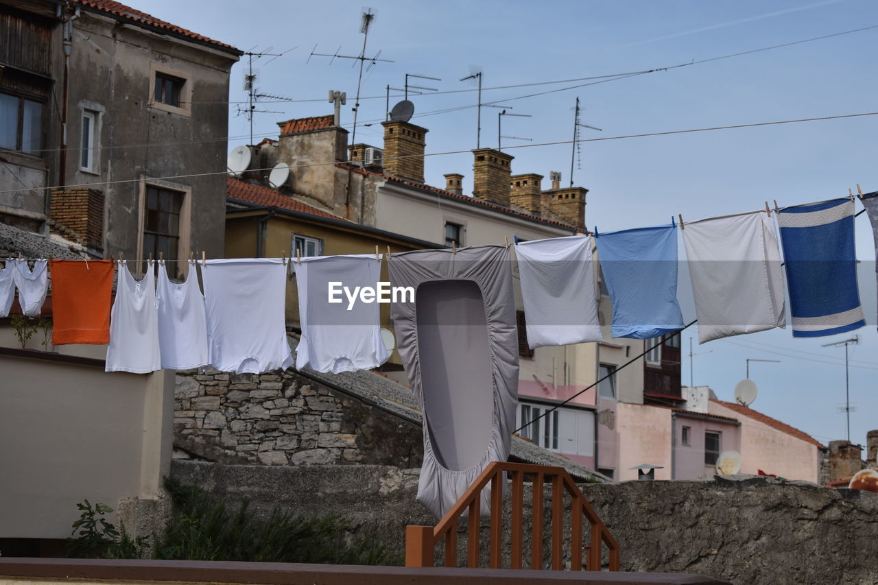 Low angle view of clothes drying outside building