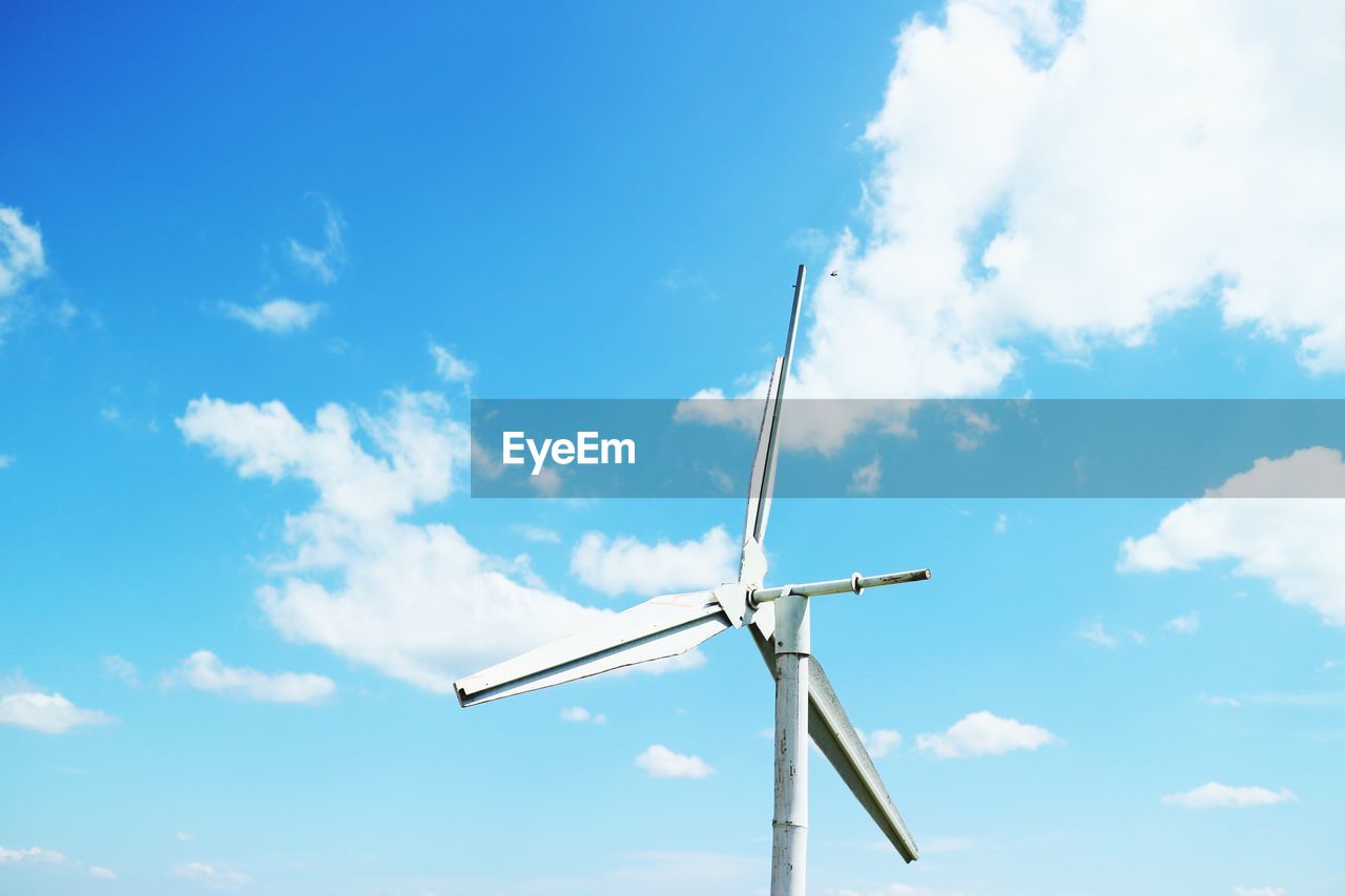 Low angle view of wind turbine against sky