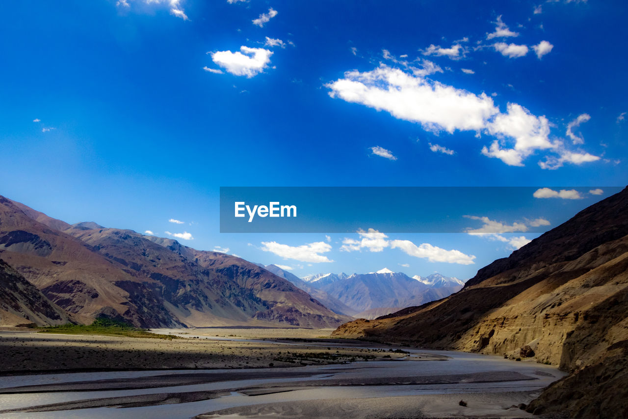 SCENIC VIEW OF MOUNTAINS AGAINST BLUE SKY