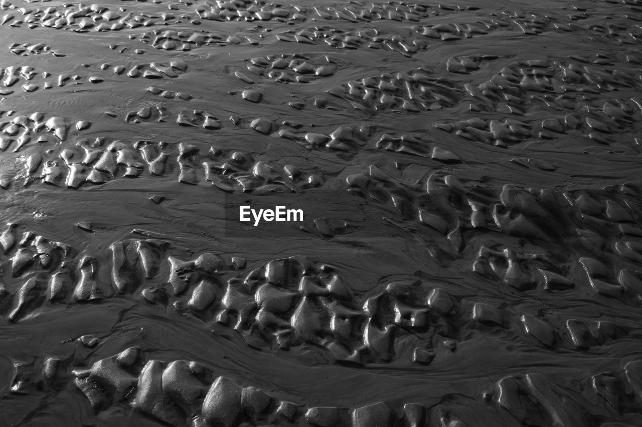 Full frame shot of sand in sea