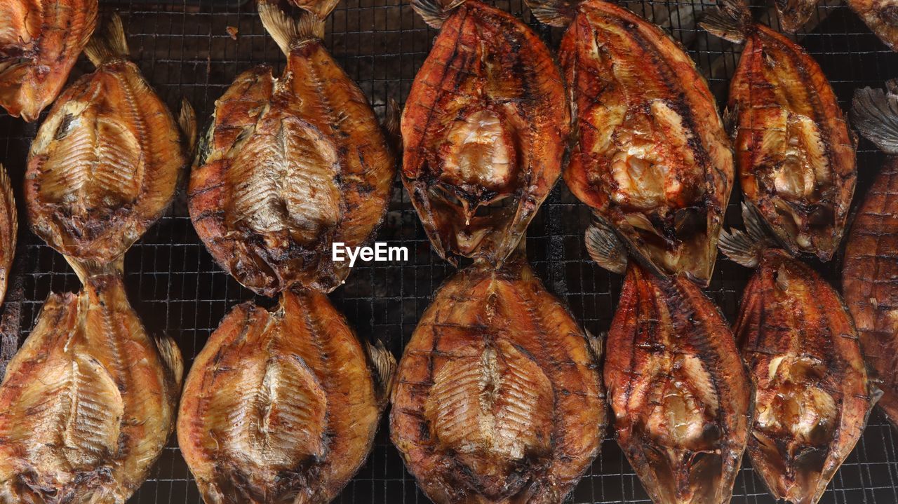 Close-up of fishes on barbecue grill