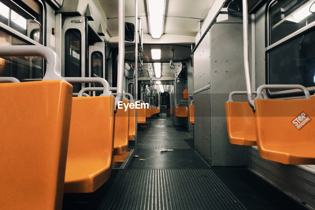 Empty orange seats in subway train