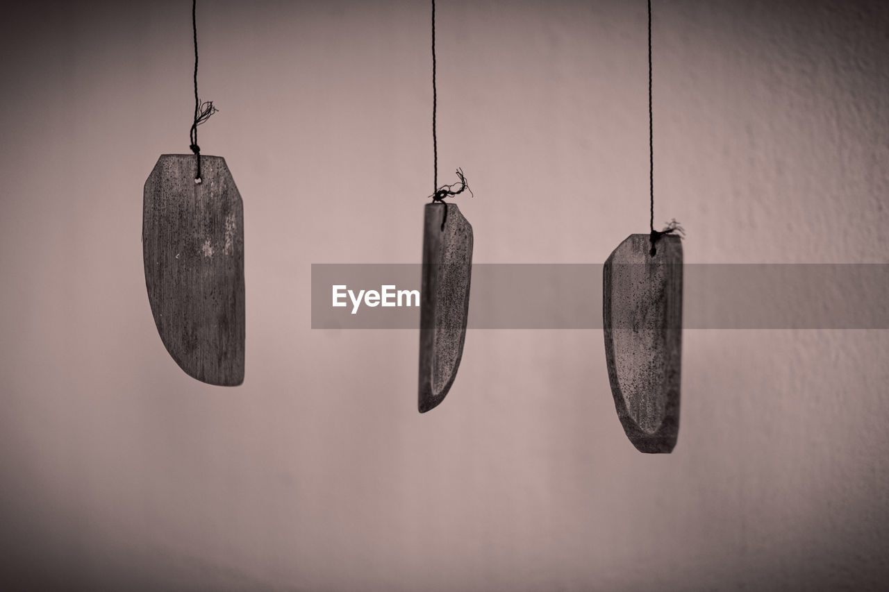hanging, black, white, no people, light, black and white, indoors, darkness, hook, earring, lighting, monochrome photography, monochrome, wall - building feature, vignette, light fixture, still life photography, close-up