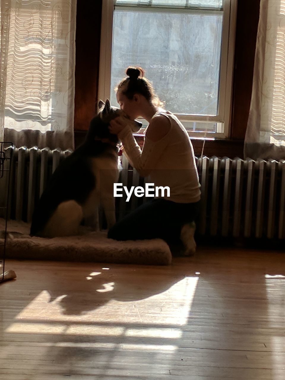 Teenage girl with dog at home