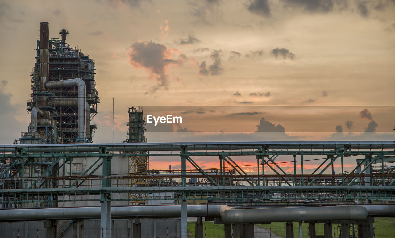Refinery tower at a petrochemical plant with cloudy sky. after sunset.