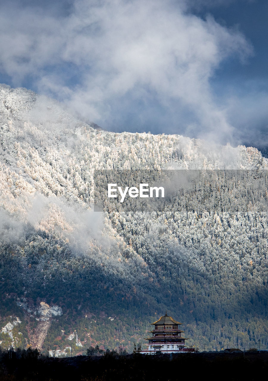 mountain, cloud, snow, environment, sky, scenics - nature, cold temperature, beauty in nature, landscape, winter, nature, mountain range, no people, travel destinations, architecture, travel, land, snowcapped mountain, tourism, outdoors, built structure, water, day, building exterior, building, tranquility, blue, tranquil scene