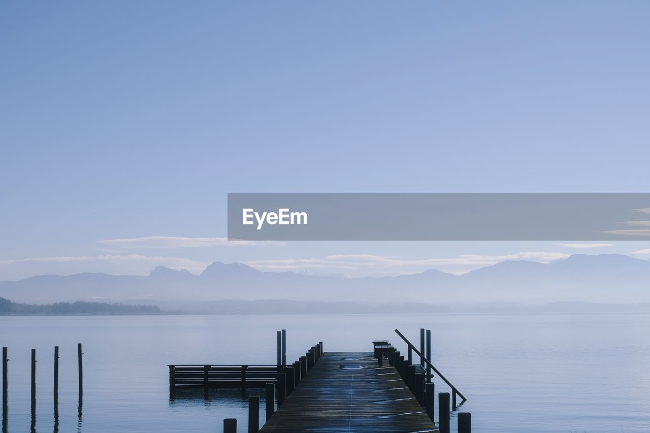 Pier over lake against sky