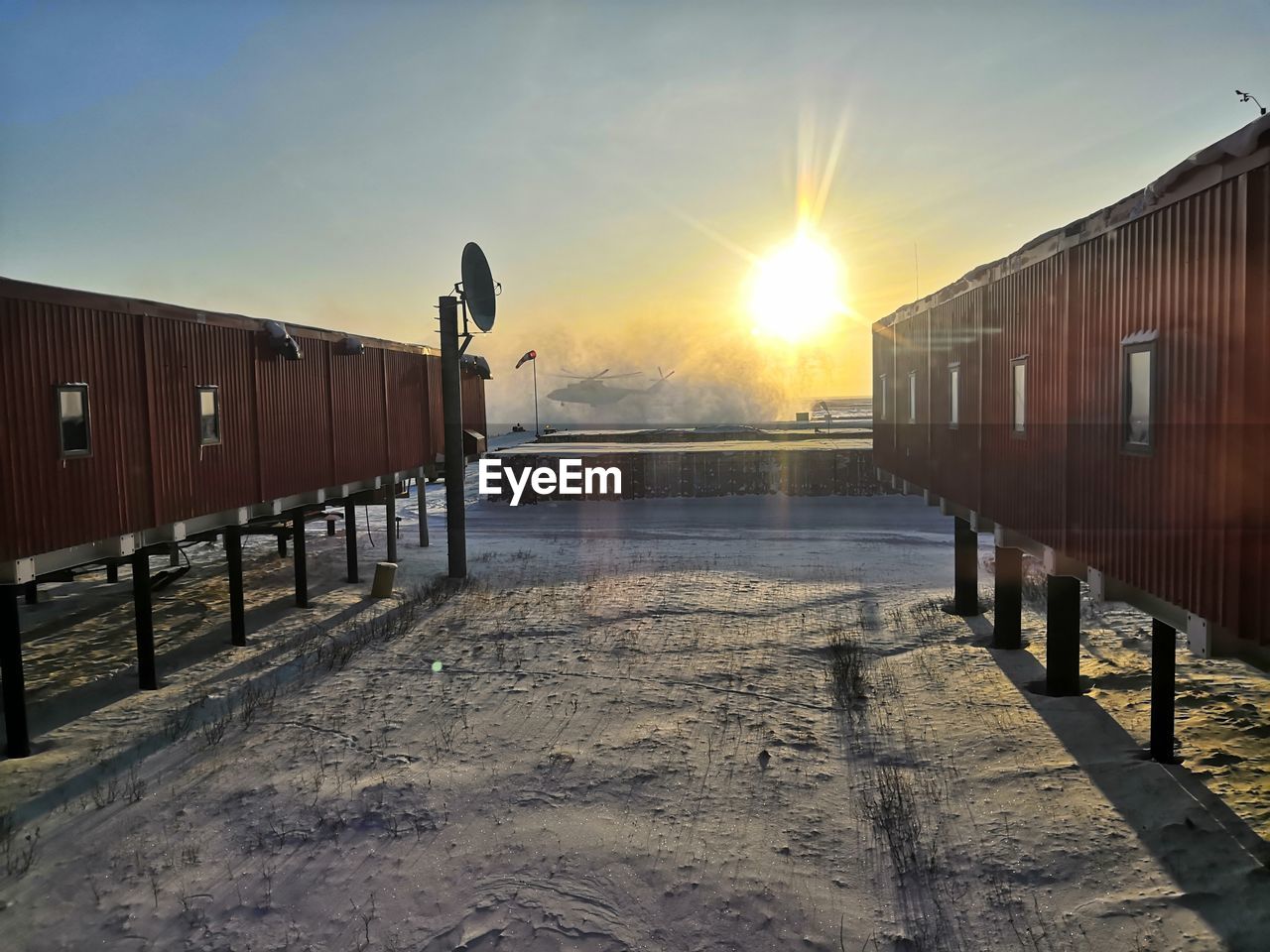 VIEW OF TRAIN IN WINTER DURING SUNSET