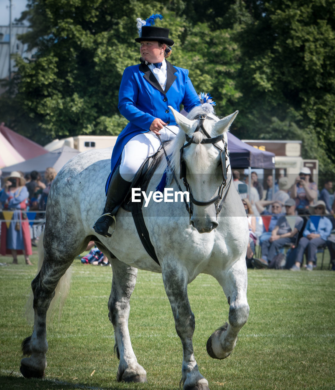 FULL LENGTH OF A MAN RIDING HORSE IN A PARK