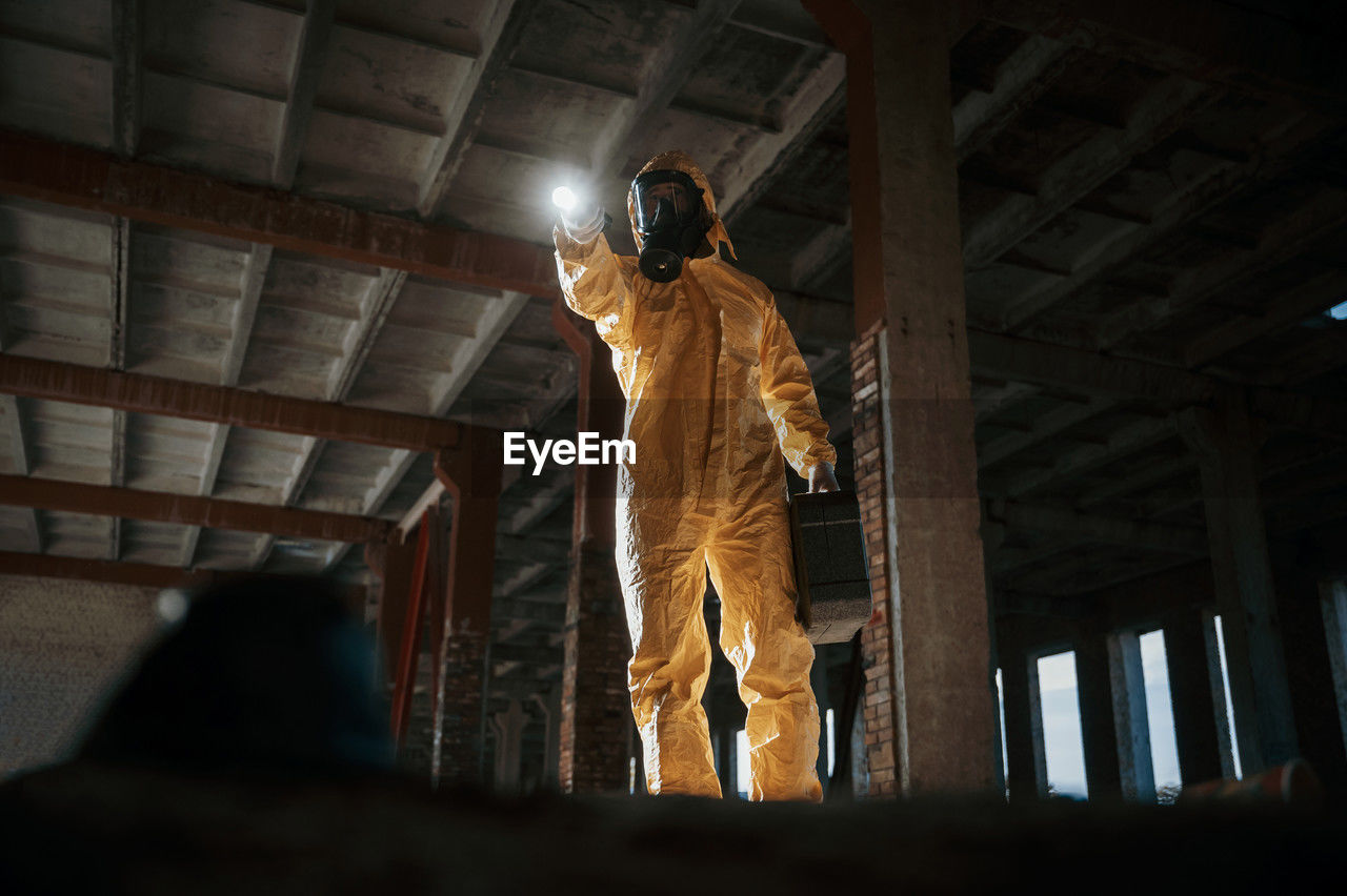 low angle view, indoors, architecture, darkness, adult, statue, standing, one person, men, built structure, clothing, screenshot