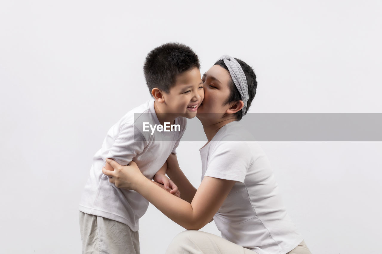 HAPPY COUPLE AGAINST WHITE BACKGROUND