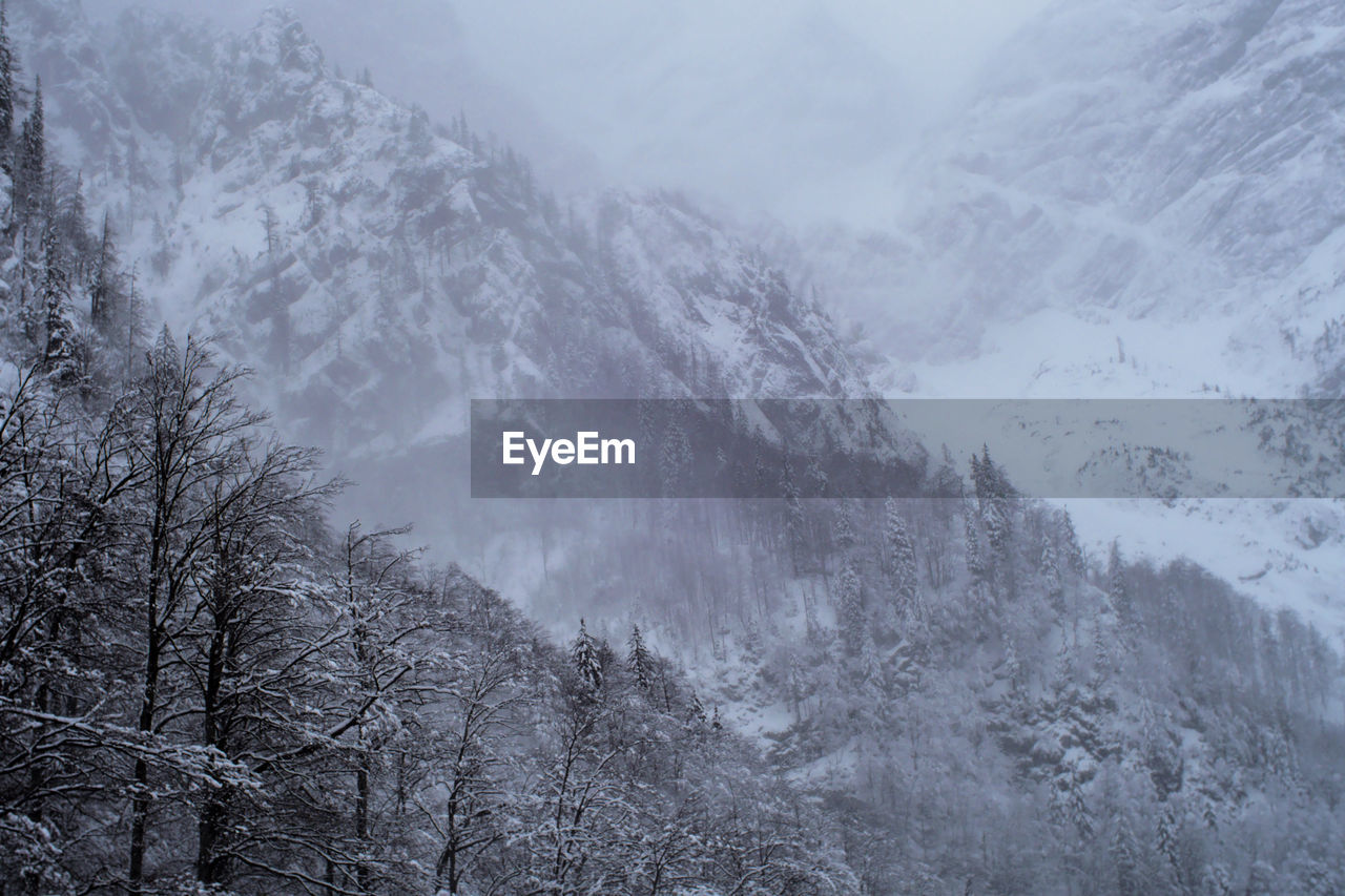 Scenic view of snow covered mountains during winter