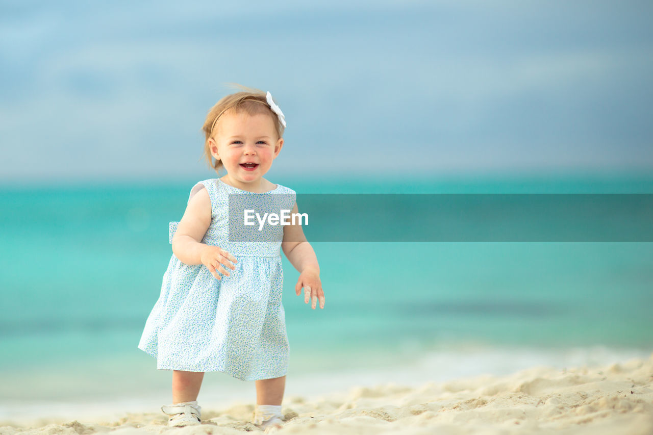 Portrait of happy girl standing on beach