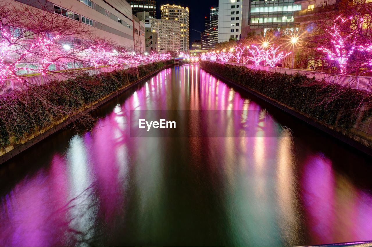 Reflection of illuminated buildings in water