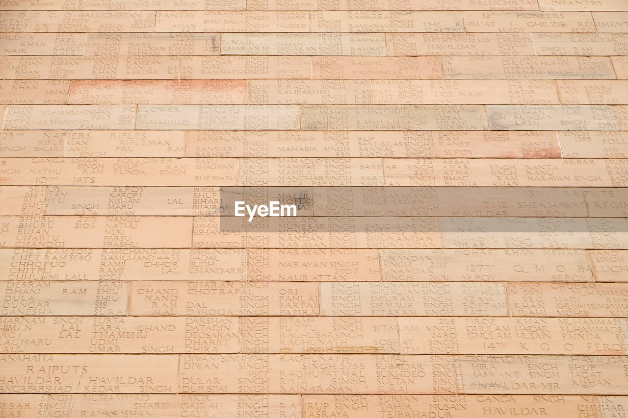 Engraved name of the soldiers on the bricks of india gate, delhi, india