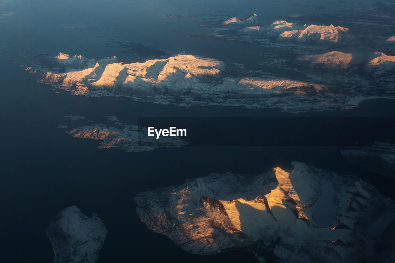 Aerial view of mountain range against sky during sunset