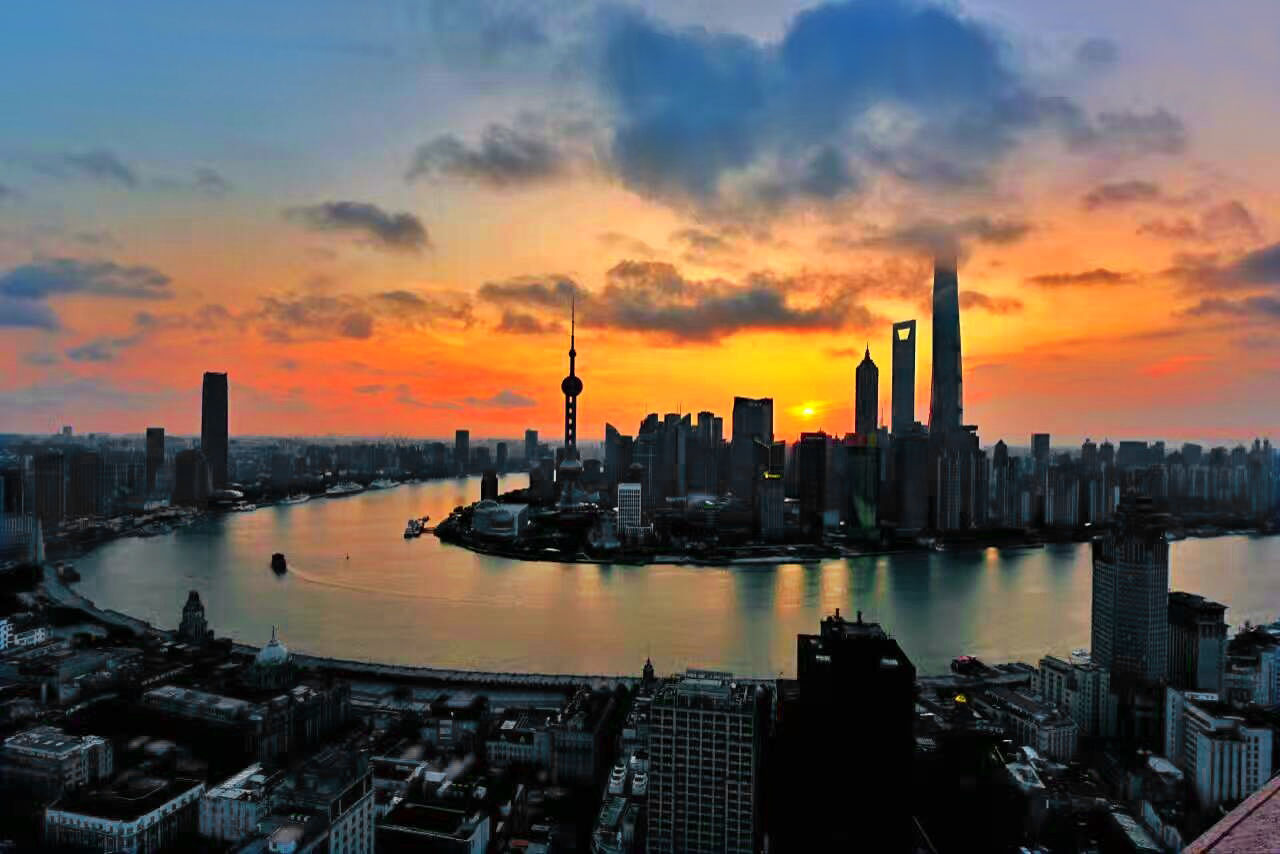 City at waterfront during sunset