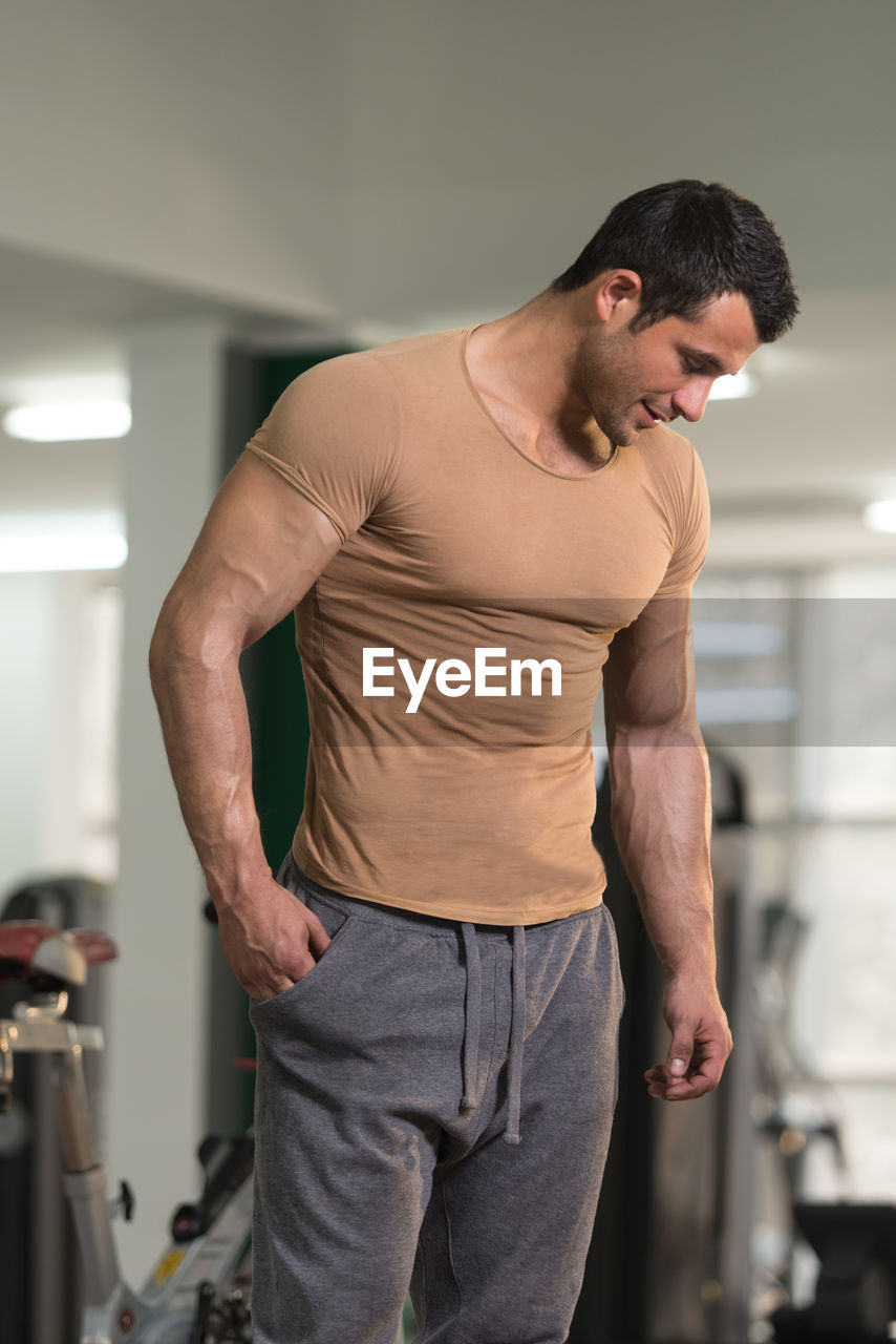 Young man standing at gym