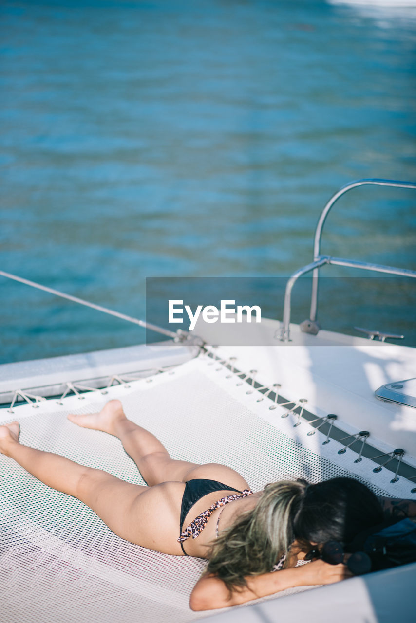 Young woman sunbathing on a boat