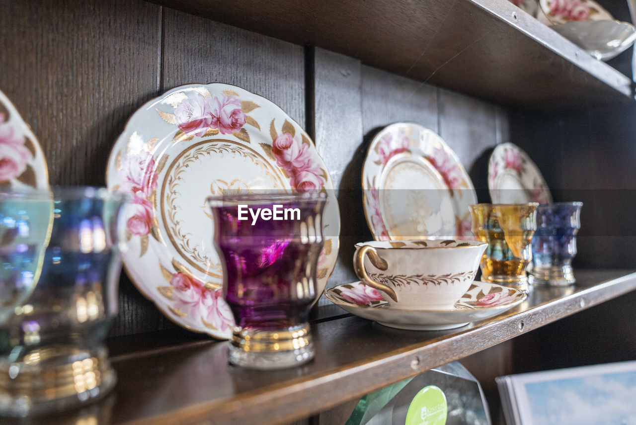 Variety of white plates tea cups and designer glass for sale at store