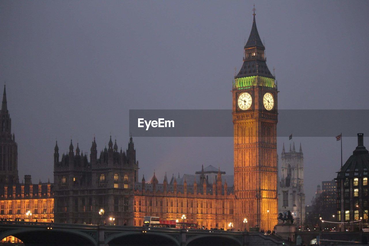 Illuminated big ben in city at dusk